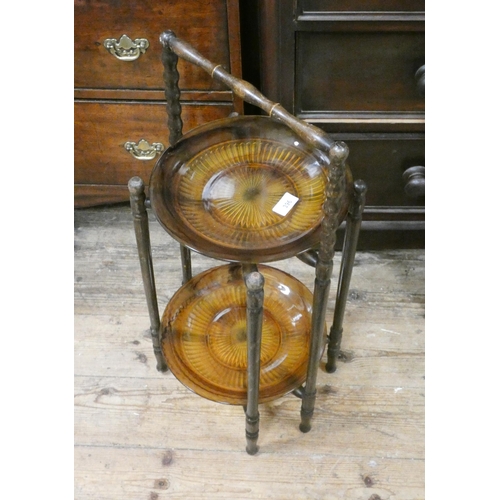 396 - A wooden two tier cake stand with amber glass dishes