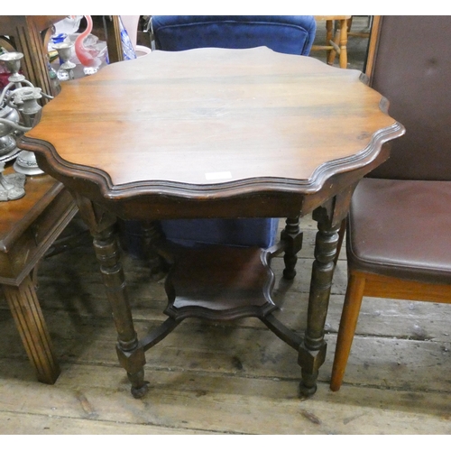 413 - A walnut two tier occasional table with pie crust edge