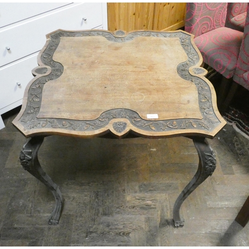 493 - A late Victorian mahogany shaped top centre table with acorn carved frieze and carved cabriole style... 