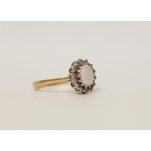 585 - An opal and diamond oval cluster ring, hallmarked 18ct yellow gold band. Ring size K, 3.3g