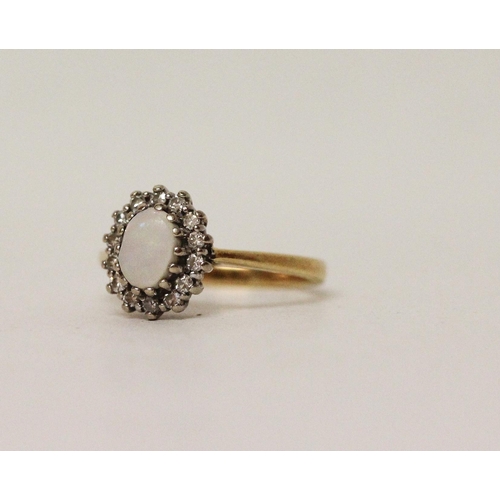 585 - An opal and diamond oval cluster ring, hallmarked 18ct yellow gold band. Ring size K, 3.3g