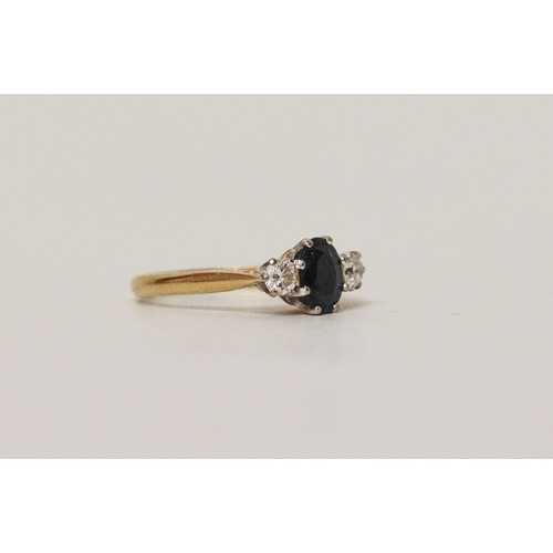 599 - A sapphire and diamond three stone ring, on 18ct gold band, stone weights marked in shank. Ring size... 