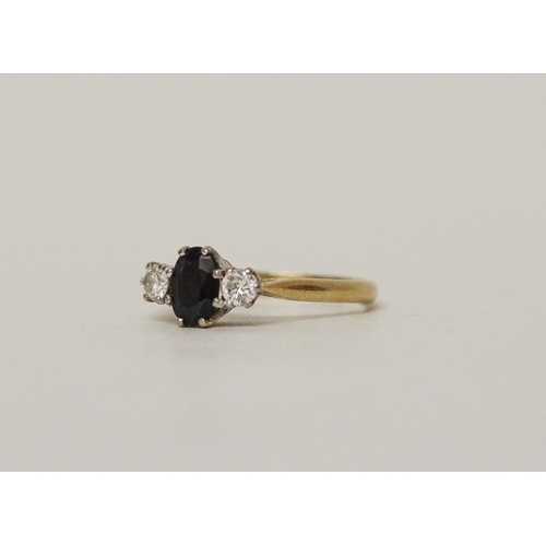 599 - A sapphire and diamond three stone ring, on 18ct gold band, stone weights marked in shank. Ring size... 