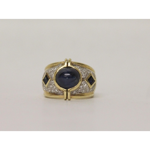 612 - A sapphire and diamond ring, the modern wide band pave set with diamonds with large sapphire cabocho... 