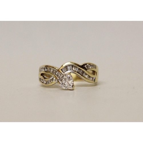 620 - A modern diamond dress ring, heart shaped diamond claw set to a channel set princess cut diamond ban... 