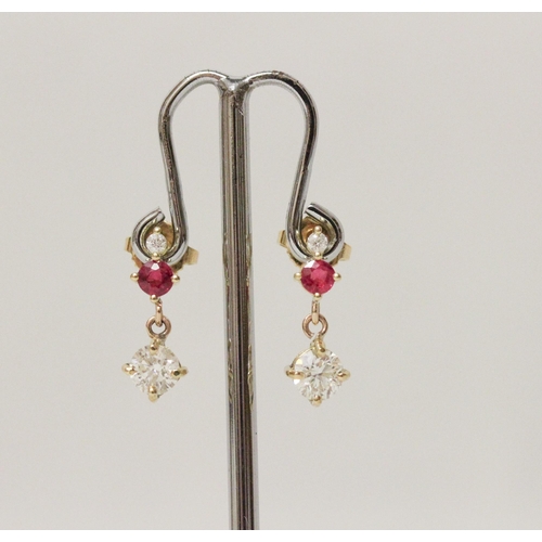 621 - A pair of ruby and diamond drop earrings, the largest diamond drops weighing approximately 45 points... 