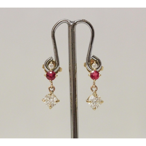 621 - A pair of ruby and diamond drop earrings, the largest diamond drops weighing approximately 45 points... 