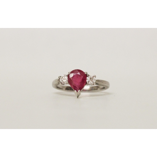 622 - A ruby and diamond three stone ring, with a large tear drop shaped ruby claw set to the centre, on h... 