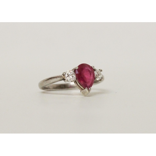 622 - A ruby and diamond three stone ring, with a large tear drop shaped ruby claw set to the centre, on h... 