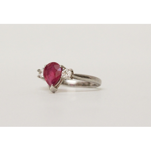 622 - A ruby and diamond three stone ring, with a large tear drop shaped ruby claw set to the centre, on h... 