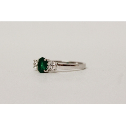 627 - An emerald and diamond ring, on hallmarked 18ct white gold band. Ring size N, 2.8g