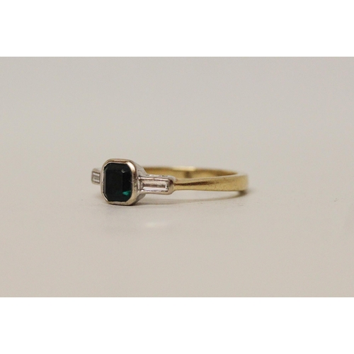 628 - An emerald and diamond Art Deco design ring, the rectangular emerald in rub over setting to baguette... 