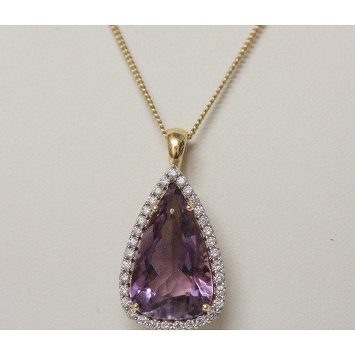 629 - A large amethyst and diamond cluster pendant, of modern triangular shape, on hallmarked 18ct yellow ... 