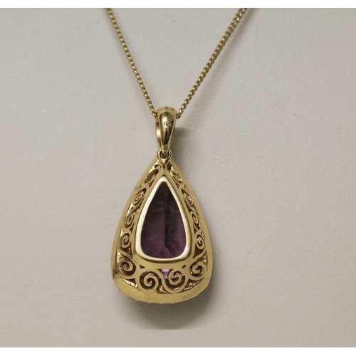 629 - A large amethyst and diamond cluster pendant, of modern triangular shape, on hallmarked 18ct yellow ... 