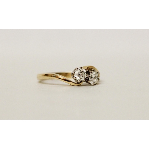 630 - A diamond two stone ring, on cross over setting, hallmarked 18ct yellow gold band. Ring size O/P, 3.... 