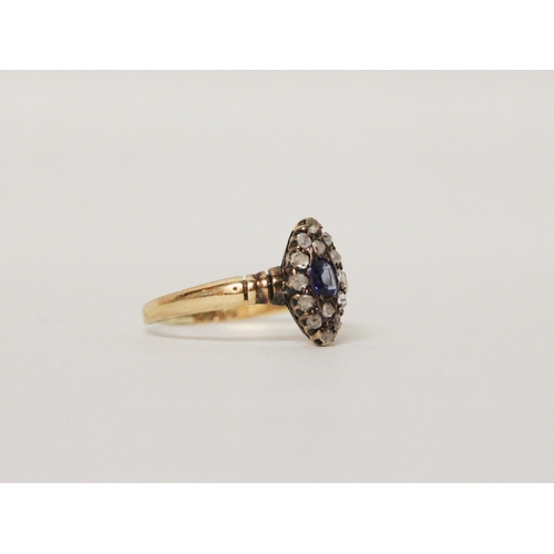 643 - An antique sapphire and diamond marquise panel cluster ring, rose cut diamonds surrounding a cushion... 