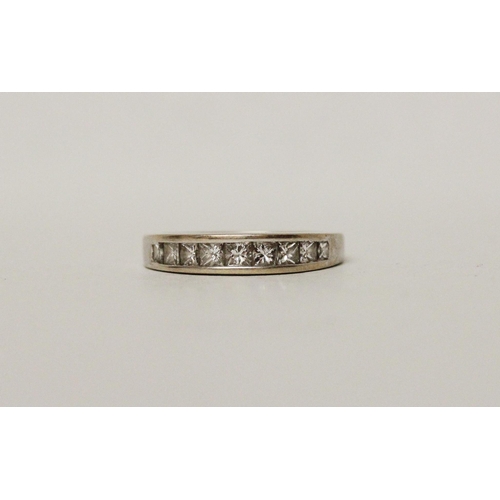 677 - A modern diamond half hoop eternity ring, channel set with 1 carat of princess cut diamonds, hallmar... 