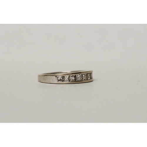 677 - A modern diamond half hoop eternity ring, channel set with 1 carat of princess cut diamonds, hallmar... 