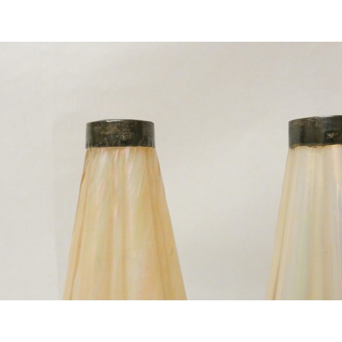 279 - A pair of Edwardian shaped lustre glass vases with hallmarked silver collars. 17 cms tall