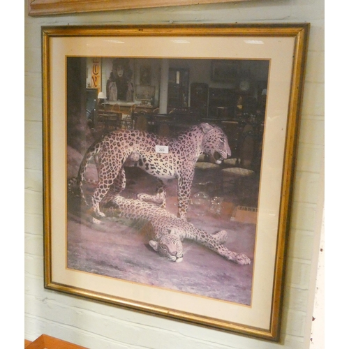 303 - A large framed still life print of flowers and another of leopards