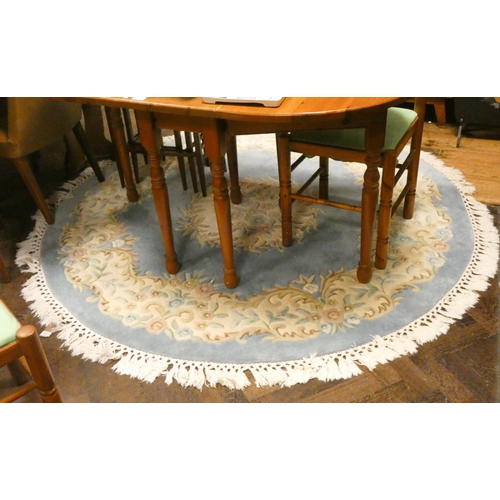 308 - A large circular blue and cream patterned fringed Chinese rug. 6'3