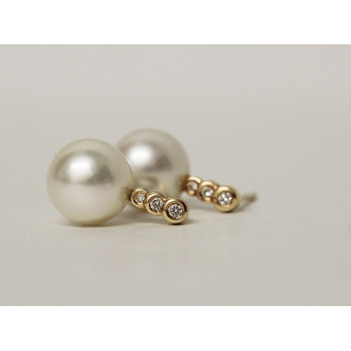 578 - A pair of South Sea pearl and diamond earrings, the 11 mm pearls suspended on 18ct yellow gold diamo... 