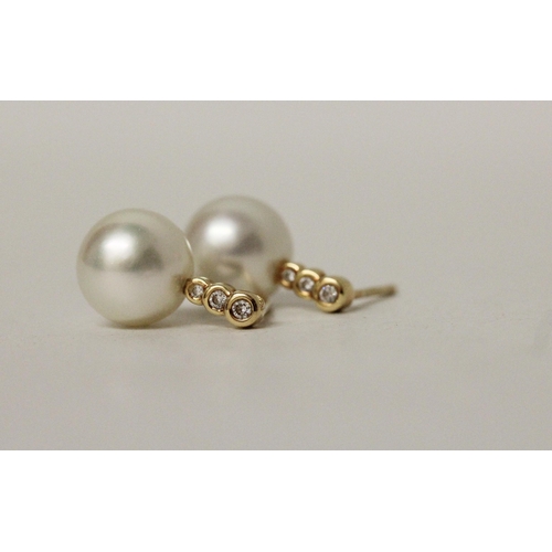 578 - A pair of South Sea pearl and diamond earrings, the 11 mm pearls suspended on 18ct yellow gold diamo... 