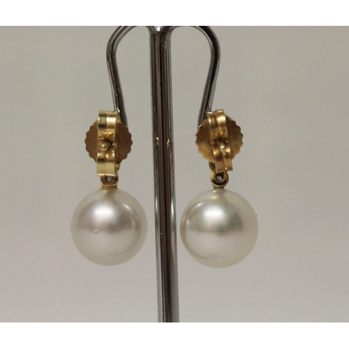 578 - A pair of South Sea pearl and diamond earrings, the 11 mm pearls suspended on 18ct yellow gold diamo... 