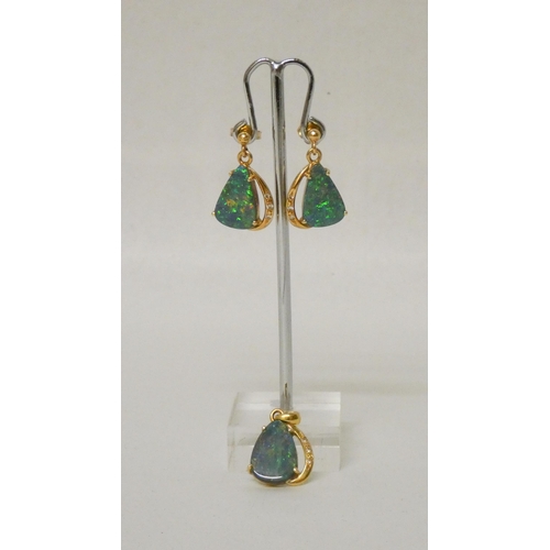 591 - Australian boulder opal and diamond drop earrings together with a matching pendant.