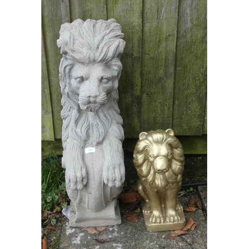 862 - A large stone figure of a lion and a smaller gold painted figure of a lion. Largest one measures 33