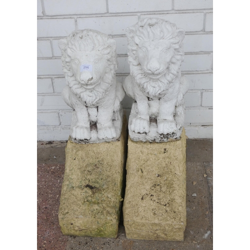 863 - A pair of white painted stone garden figures of lions both on stone bases