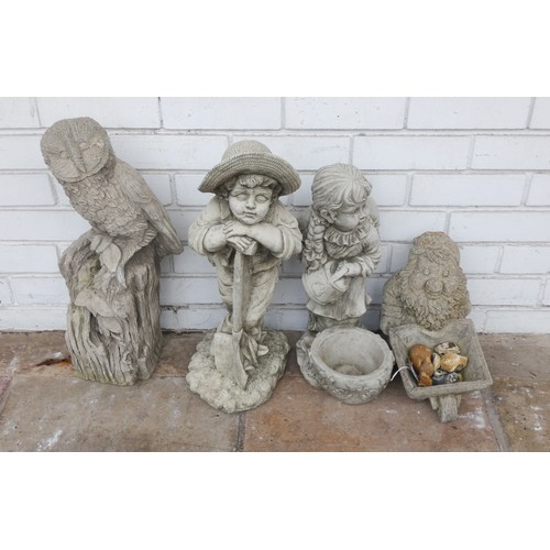 864 - Concrete garden owl ornament, boy & girl and a garden ornament of a gnome pushing a wheelbarrow