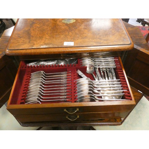 495 - Victorian walnut canteen  box, the cupboard style doors opening to three cutlery drawers, full of la... 