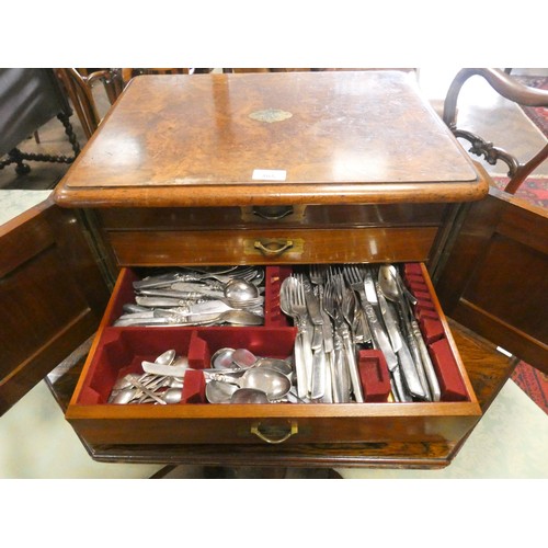 495 - Victorian walnut canteen  box, the cupboard style doors opening to three cutlery drawers, full of la... 