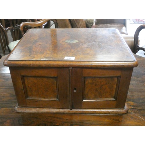 495 - Victorian walnut canteen  box, the cupboard style doors opening to three cutlery drawers, full of la... 