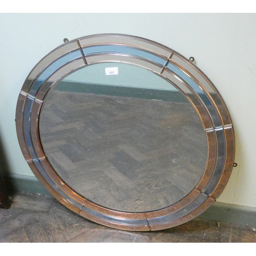 497 - An Art Deco circular frameless mirror, inset with peach and powder blue glass, 30