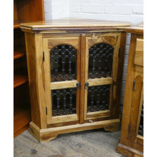 28 - An Indonesian Sheesham corner cupboard with decorative iron doors matching the sideboard