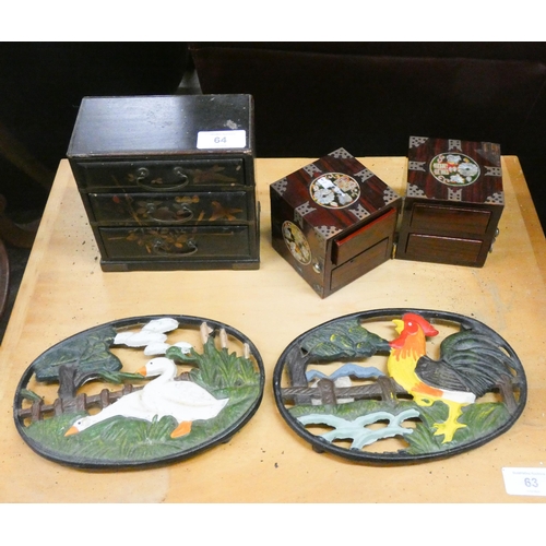 64 - A miniature lacquered chest of three drawers, inlaid miniature chest and two iron teapot stands