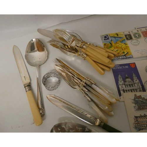 82 - A collection of assorted cutlery and stamps