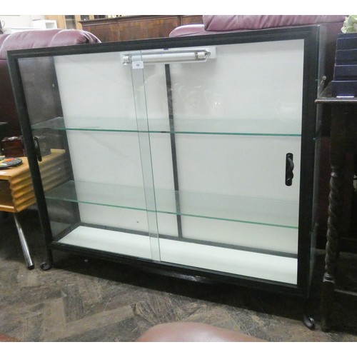 66 - A glazed shop display cabinet with sliding doors, 3'6