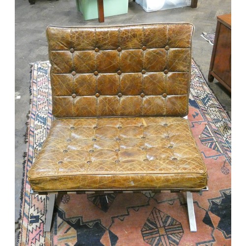 500 - After Mies Van der Rohe, a Barcelona chair upholstered in antiqued brown leather on chrome base