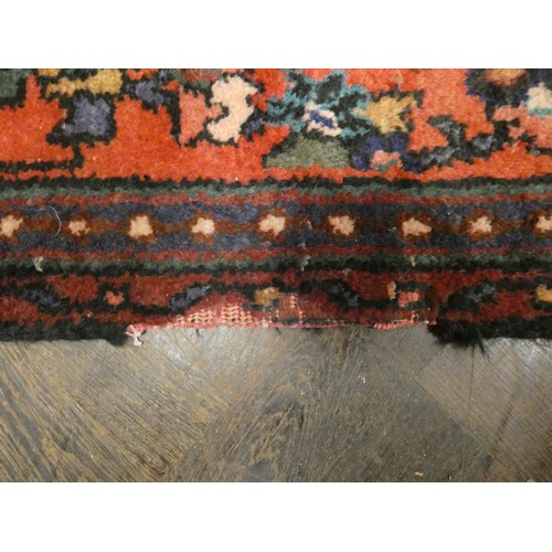 370 - A large red and figured wool pile Persian design rug 2.5m x 1.56m