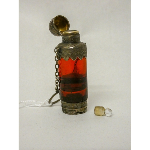 504 - A 19th century ruby glass scent bottle vinaigrette, white metal and gilded mounts unmarked. 7cms lon...