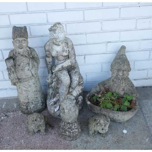 419 - Six stone concrete garden figure ornaments to include an owl, a gnome, a planter, dogs etc