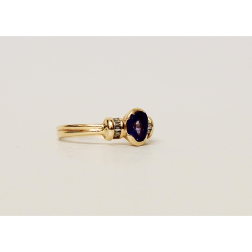 641 - A Ceylon sapphire and diamond ring, the oval sapphire flanked by baguette cut diamonds, on 18ct yell... 