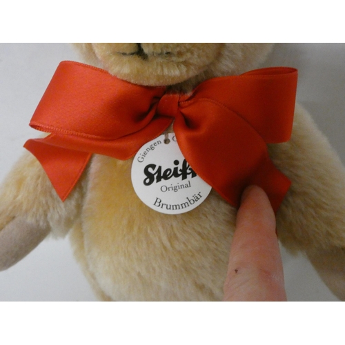 217 - A Steiff golden plush joined teddy bear in fitted box. Teddy bear is 23cm tall with growler