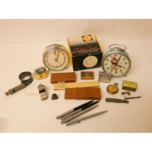 218 - Collectables to include two vintage alarm clocks, a gold plated pocket watch, some unusual lighters,... 