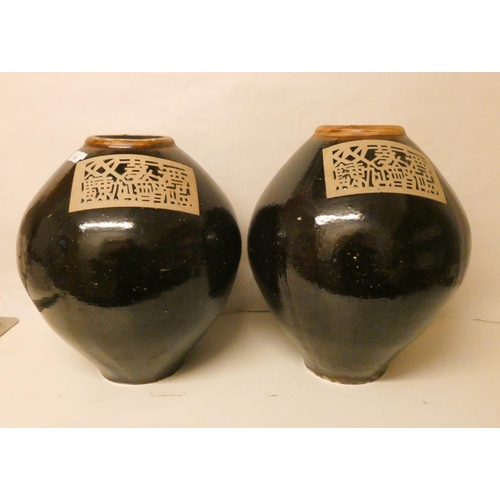 219 - A large pair of Chinese Cheng rice wine vases, standing 45cm tall