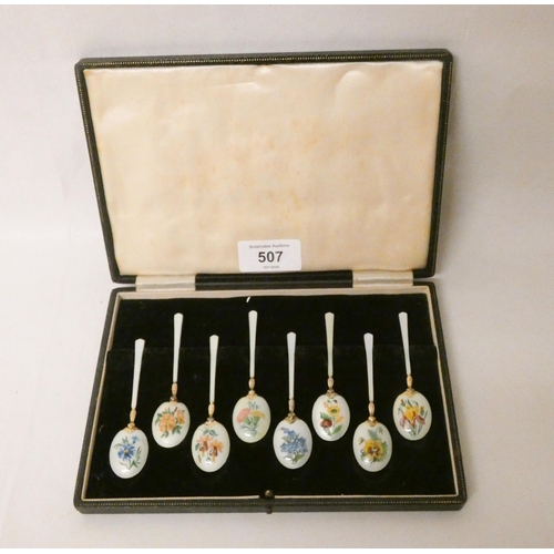 507 - A set of eight hallmarked silver gilt and enamel coffee spoons, enamelled with summer flowers, in a ... 