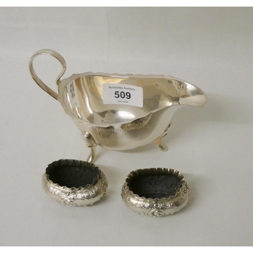 509 - A hallmarked silver sauce boat together with a pair of oval embossed salt cellars, gross weight 5.2 ...